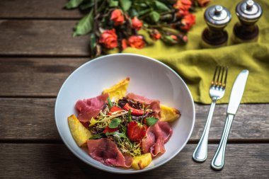 İştah açıcı jambon, çilek ve filizi kase ahşap tablo