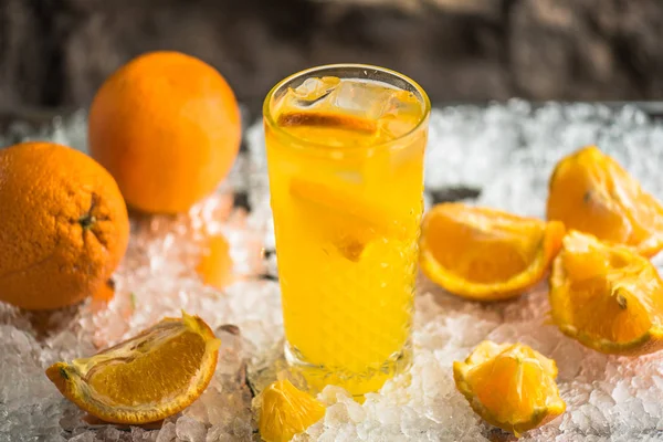 Orange drink in cocktail glass served in ice