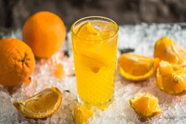 Orange drink in cocktail glass served in ice