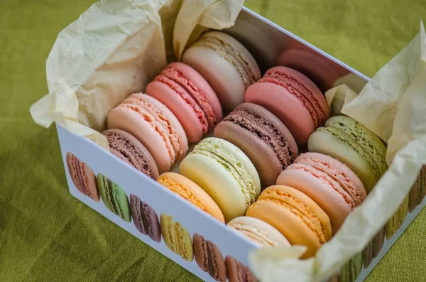 Colorful italian macaroons in metal box with paper