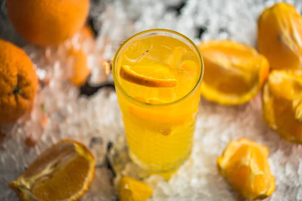 Orange drink in cocktail glass served in ice