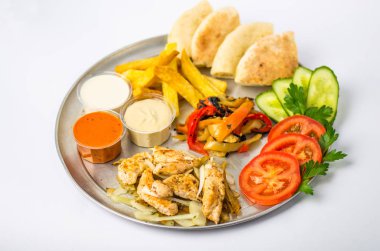 çerez tabağı taze ve kızarmış sebze, tavuk, soslar ve beyaz zemin üzerine ekmek