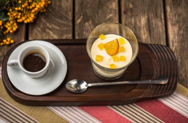 Krem peynir meyve tatlı tepsi ahşap masa üzerinde kahve Kupası ile cam