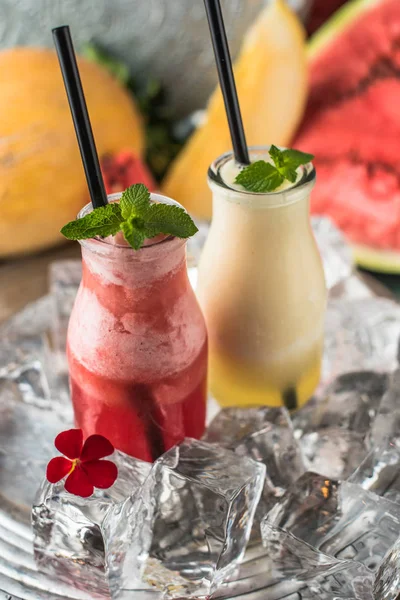 Fruit refreshing drink in glasses on ice