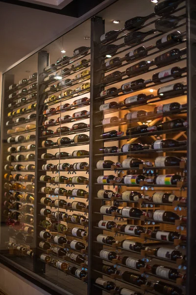 The interior of the house, restaurant. The wall of wine bottles. Showcase