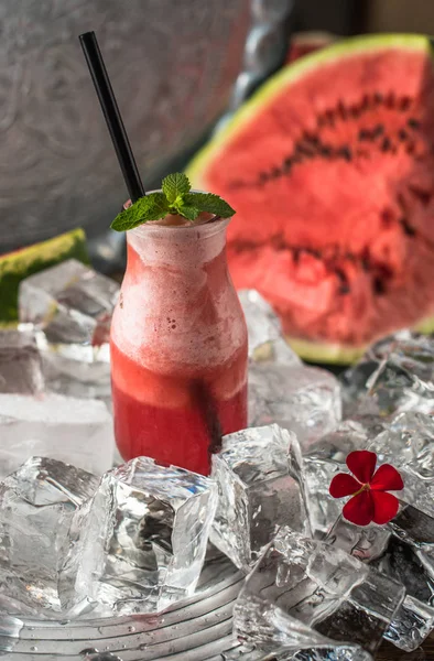 Fruit refreshing drink in glass on ice