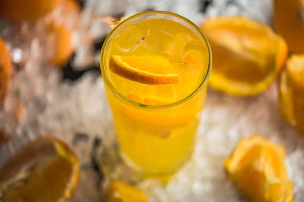 Orange drink in cocktail glass served in ice