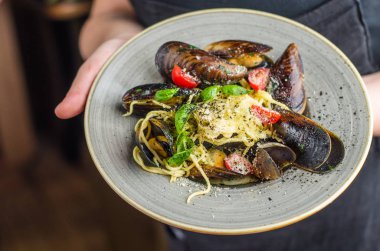 insan elinden tutarak midye sos plaka üzerinde hazırlanan