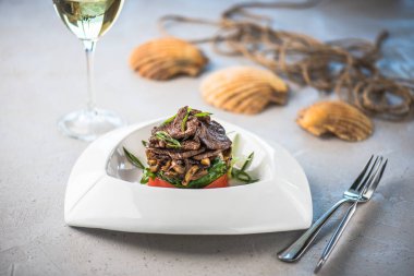 Beyaz tabakta et ve sebze yemek