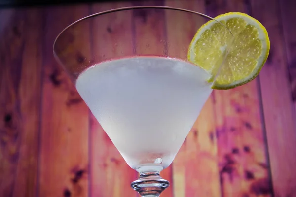 White Lady Cocktail in martini glass decorated slice of lemon