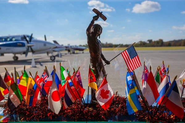 Statue of a Boy with an airplane and country flags