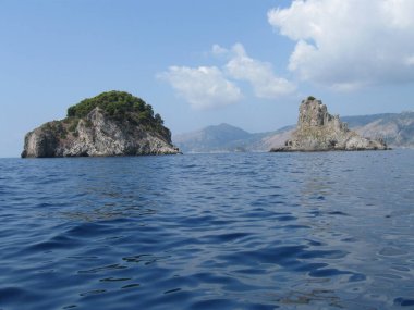 Seascape with rocks in the distance on a summer sunny day in the Tyrrhenian Sea, Italy.