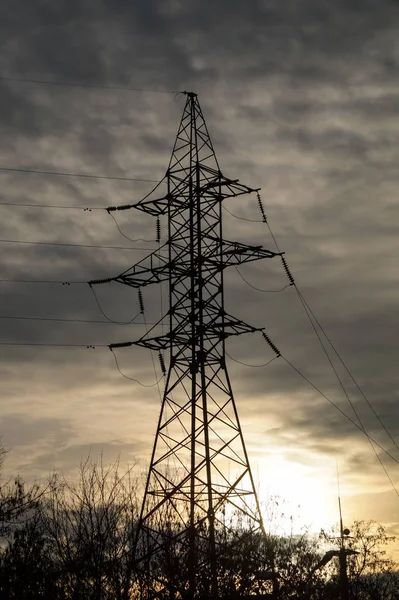 High voltage electric metal pillar at sunset.