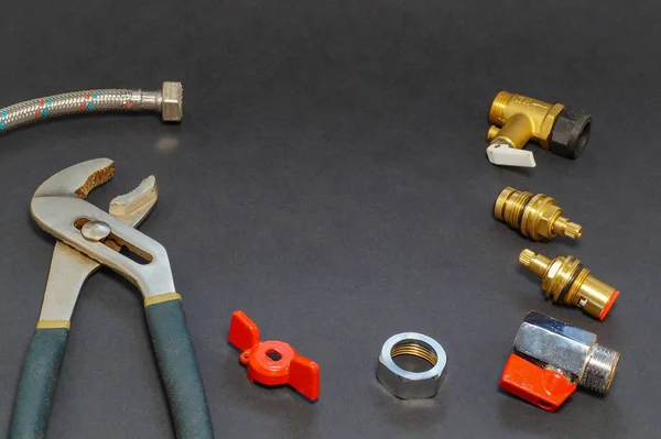 Plumbing accessories and tools on gray background. — Stock Photo, Image