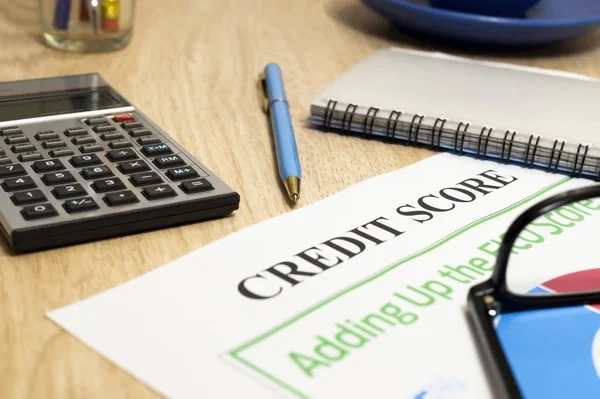 Credit score report with calculator on a table. — Stock Photo, Image