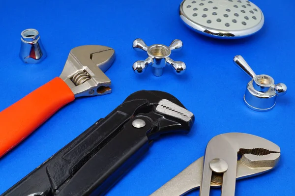 Plumbing work tools on a blue background.