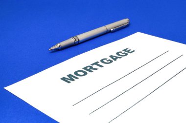 Mavi bir arka plan üzerinde kalem ile ipotek.