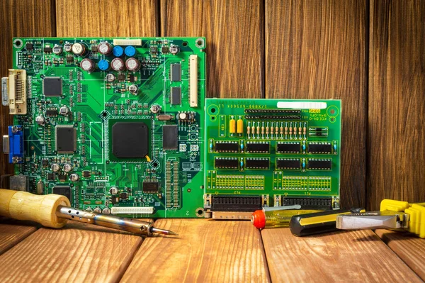 Services and repair of electronics, electronic boards. Wooden background