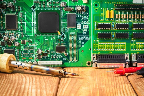 Services and repair of electronics, electronic boards. Wooden background
