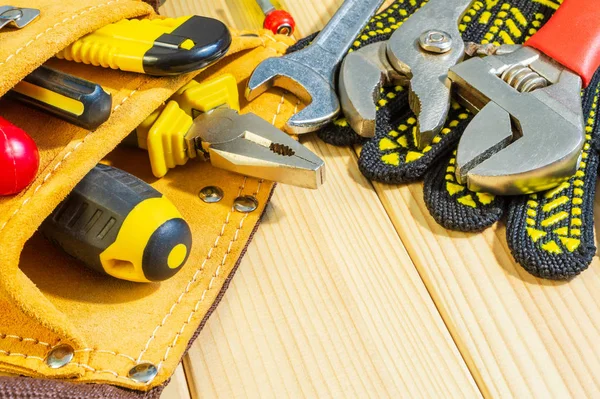 Necessary set of tools in the bag for plumbers on a wooden background. — Stock Photo, Image