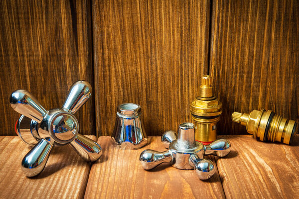 Accessories for plumbing repairs or washing in the kitchen on a wooden background.