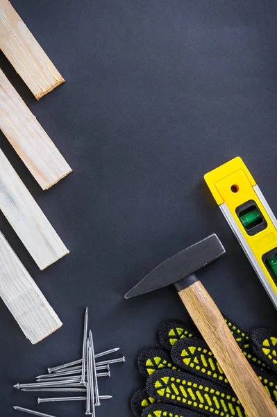 Professional tools for carpentry and accessories on a black background.