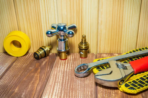 Plumbing repair supplies and tools on wooden, antique background. — Stock Photo, Image