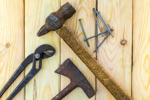 Rusty old tools are laid out on a wooden background — Stock Photo, Image