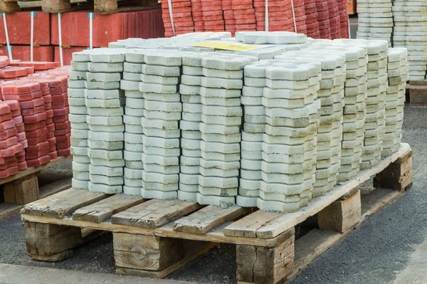 Tiles piled in pallets, warehouse paving slabs in the factory for its production