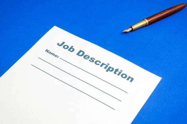 Job description template on the blue office desk with pen, business idea