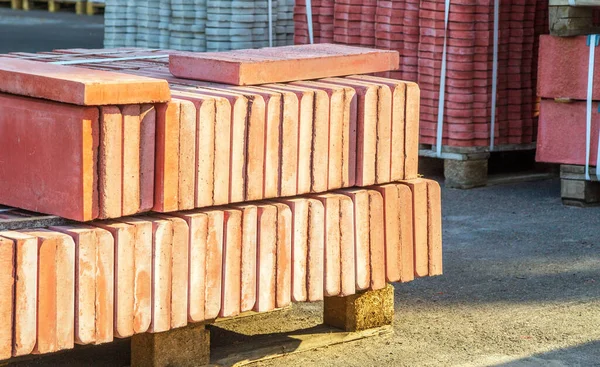 Red tiles piled in pallets warehouse paving slabs the factory for its production