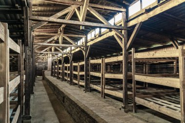 Wooden bunk beds in a barrack in Auschwitz - Birkenau Concentration Camp, Poland clipart
