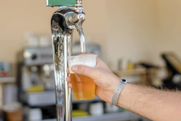Hombre vertiendo cerveza fresca en el bar de autoservicio - con todo incluido —  Fotos de Stock