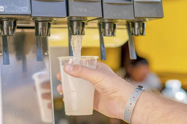Man pouring fresh drink in self service bar