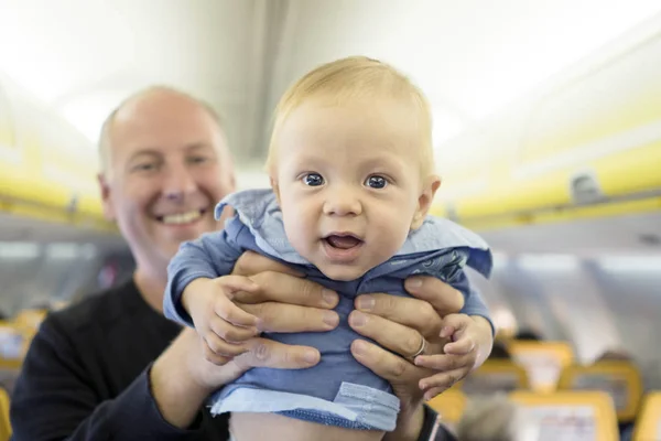 Father with his six months old baby boy in the airplane — Stock Photo, Image