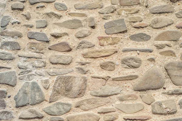 Irregular stones creating warm, natural background — Stock Photo, Image