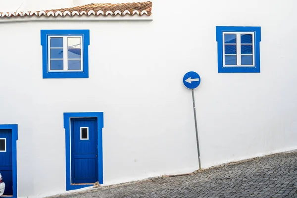 Blue windows, doors and road sign in mediterranean village — Stock Photo, Image