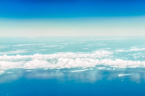 A view of the sky and clouds from the airplane window. Below is the Black Sea water.