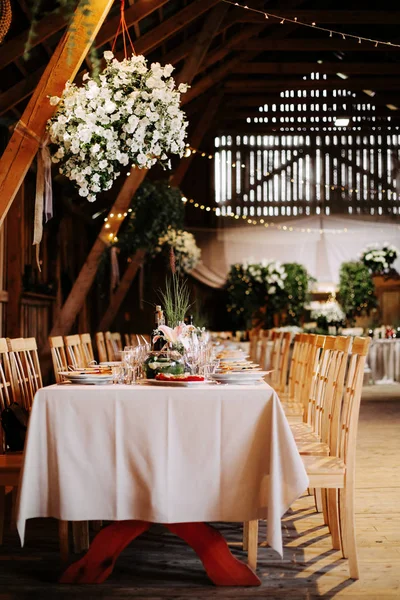 Interior of an old wooden hall with decorated tables.