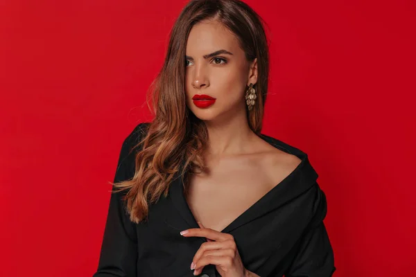 Kırmızı arka plan üzerinde parlak makyaj ve dalgalı saç modeli ile güzel kadın modeli Glamour portre 