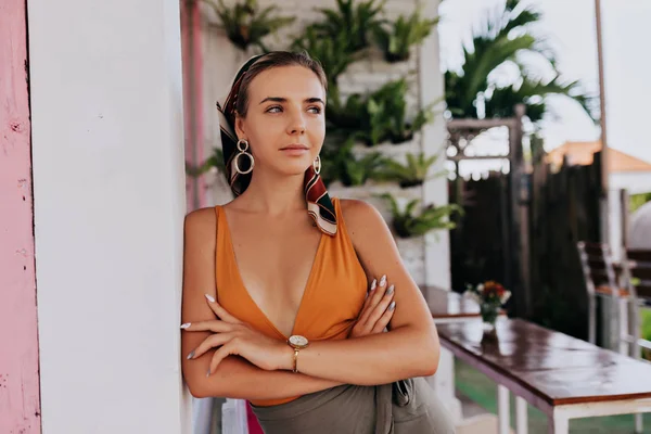 Young  attractive european woman wearing summer outfit posing on summer terrace over exotic plants — 스톡 사진