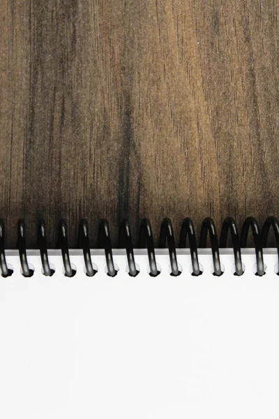 Spiral notepad paper on the wooden background