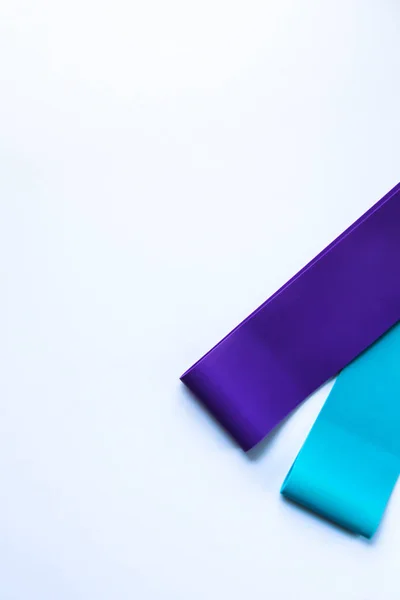 Fitness elastic band, elastic extenders of different colors for sports, isolated on a white background. Fitness trend
