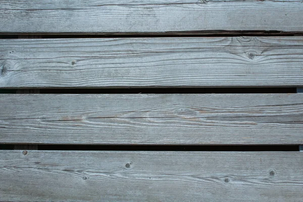 Natural knotted gray weathered wood plank texture background. Wooden floor texture, gray wood, large boards, texture.