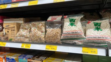Ottawa ON, Canada - August 29, 2025: Dry tapioca pearls are neatly arranged on supermarket shelf, featuring colorful packaging for bubble tea ingredients