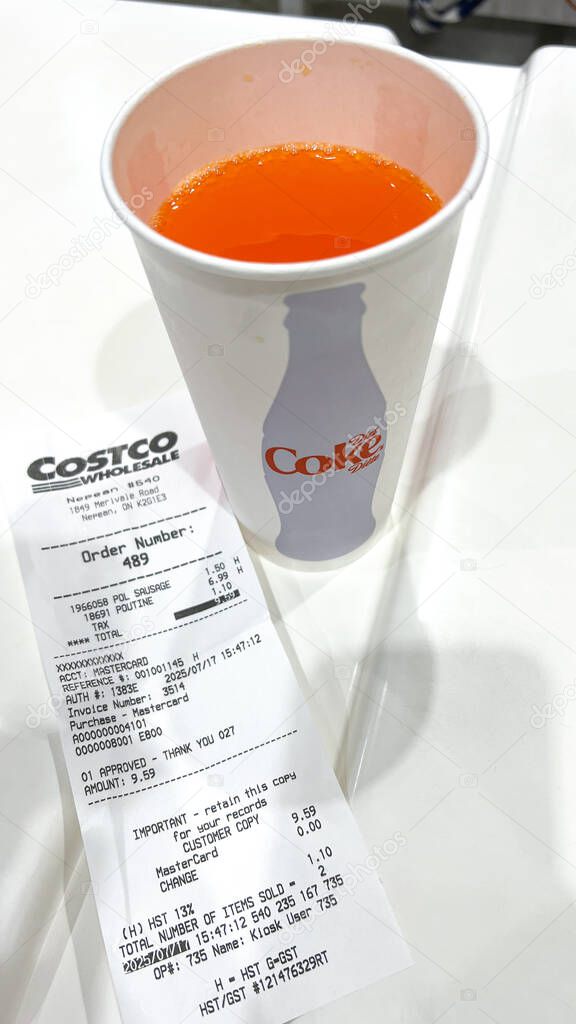 Ottawa, ON Canada - July 19, 2025: Coca-Cola drink served in a Costco cup with a receipt on a table highlighting a lively food court atmosphere. transition from Pepsi to Coca-Cola beverage