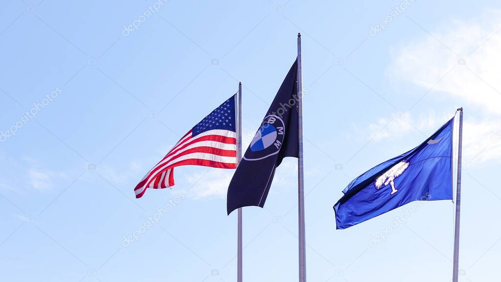 Spartanburg SC, United States - December 25, 2024: Flags of BMW, USA, and South Carolina flying at Spartanburg manufacturing plant showcasing patriotism