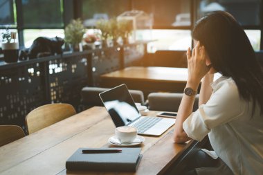 İş kadını baş ağrısı kafe, Asya kadın yorgun, stess veya süre dijital dizüstü bilgisayar ve kahve dükkanı işyerinde çalışan smartphone ile serbest.