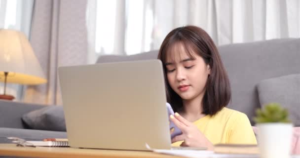 Jovem Mulher Asiática Trabalhando Computador Portátil Usando Celular Enquanto Está — Vídeo de Stock