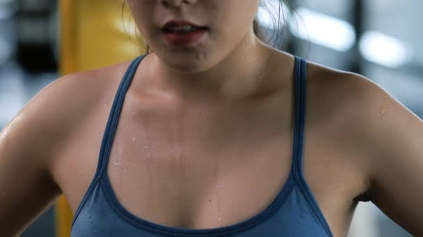 特写慢动作 体态肥胖的年轻亚洲女人在做完体操后 身体上流汗累人 运动员在健身房做了紧张的运动之后 休息一下 把目光投向别处 树立健康的生活方式观念 — 图库视频影像